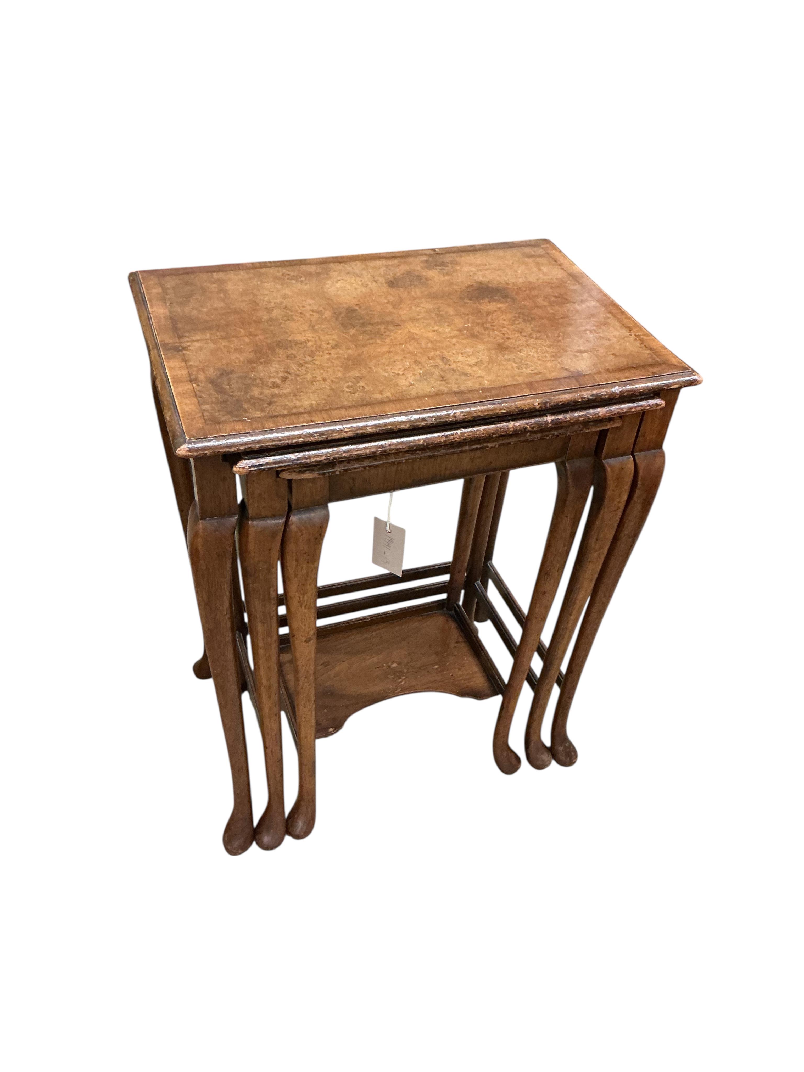 A Waring and Gillows nest of banded walnut tables, width 48cm, depth 32cm, height 60cm